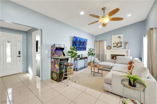 living room with lofted ceiling, light tile patterned floors, a brick fireplace, and a healthy amount of sunlight