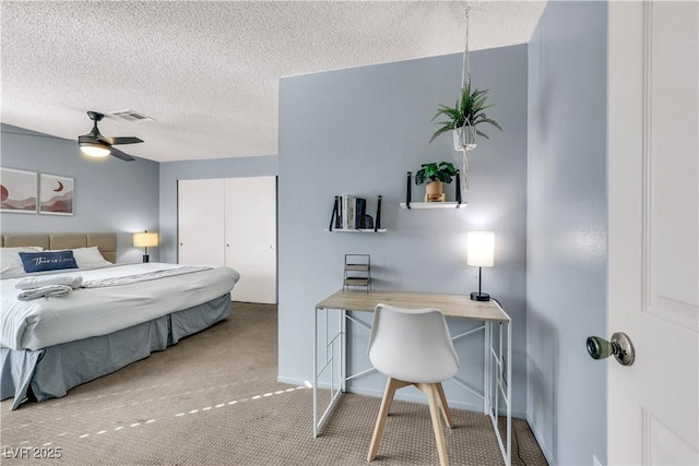 bedroom with baseboards, visible vents, ceiling fan, carpet, and a textured ceiling