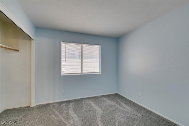 unfurnished bedroom featuring a closet and carpet flooring