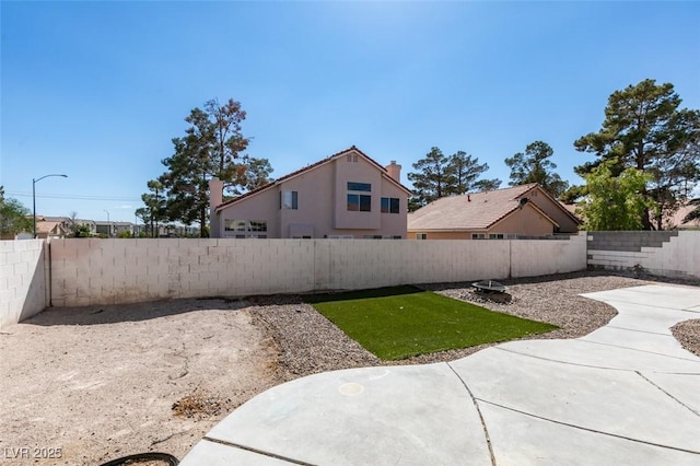 view of yard featuring a patio area and a fenced backyard