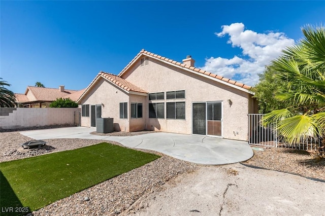 back of house featuring a tile roof, stucco siding, central AC unit, a patio area, and fence