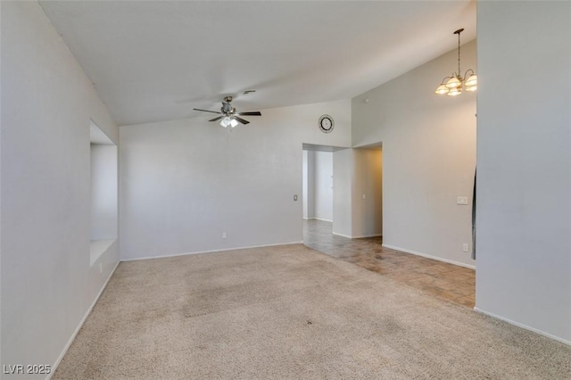 carpeted spare room with high vaulted ceiling, baseboards, and ceiling fan with notable chandelier