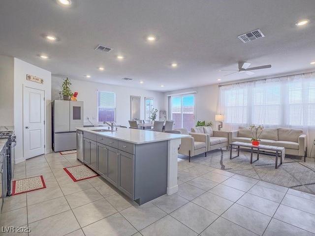 kitchen featuring gray cabinets, visible vents, stainless steel appliances, and a sink