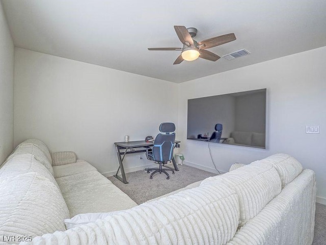 carpeted office space with visible vents, baseboards, and a ceiling fan