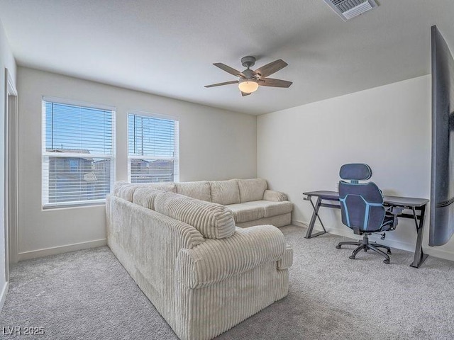 living room with baseboards, visible vents, a ceiling fan, and carpet