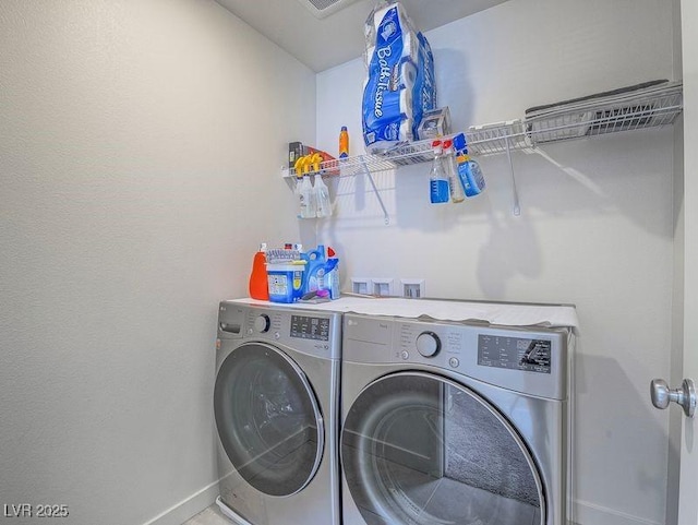 laundry room featuring laundry area, washing machine and dryer, and baseboards