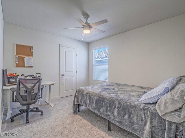 bedroom with a ceiling fan and light carpet