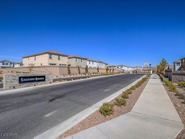 view of road featuring a residential view, curbs, and sidewalks