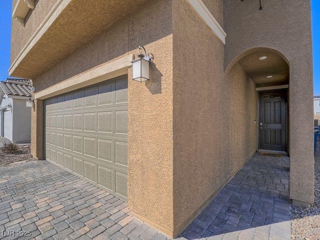 exterior space with stucco siding and a garage