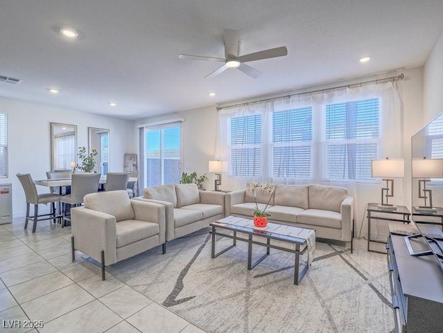 living area featuring light tile patterned floors, visible vents, ceiling fan, and recessed lighting