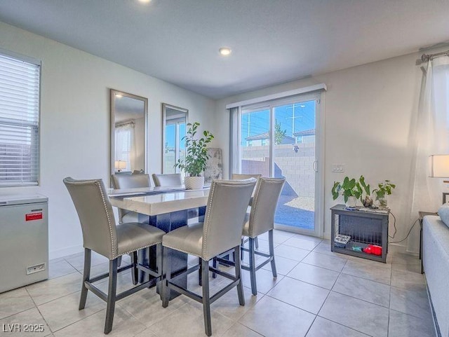 dining room featuring light tile patterned floors and baseboards