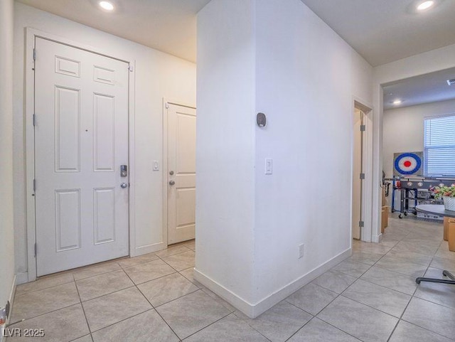 hall with light tile patterned floors, recessed lighting, and baseboards