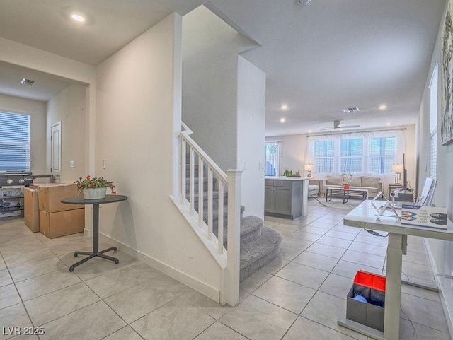 stairs featuring tile patterned floors, visible vents, baseboards, and recessed lighting