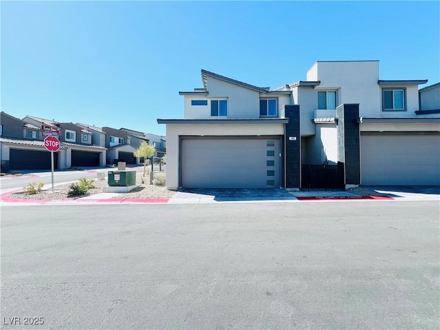 view of front of house with stucco siding and a garage