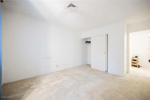 interior space featuring carpet flooring and visible vents