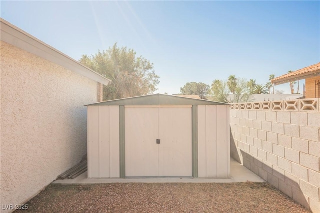 view of shed with fence