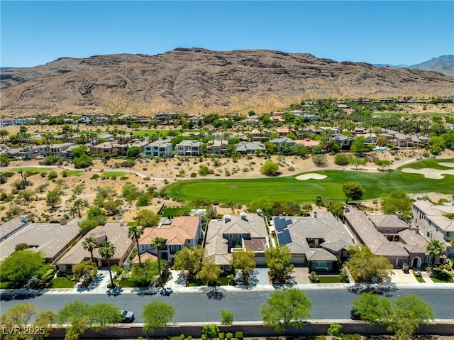 drone / aerial view featuring view of golf course, a residential view, and a mountain view