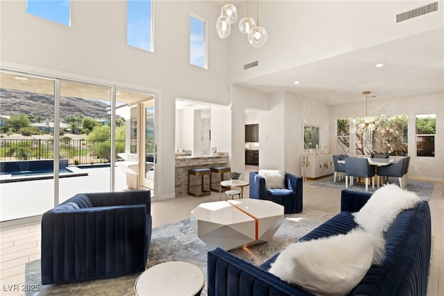 living room featuring visible vents, a notable chandelier, and recessed lighting