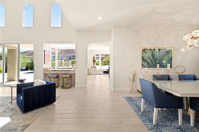 dining space featuring recessed lighting, baseboards, a wealth of natural light, and wood finish floors