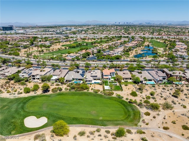 aerial view with view of golf course, a residential view, and a water and mountain view