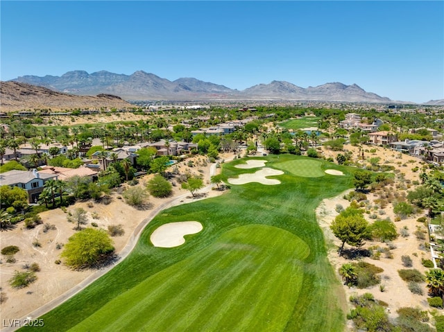 bird's eye view with golf course view and a mountain view