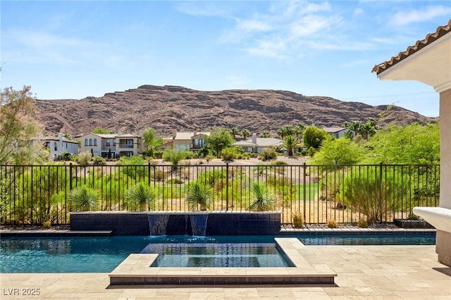 view of pool with fence, a mountain view, and a fenced in pool