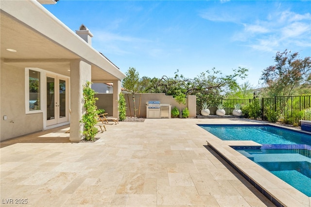 view of pool with a patio, an outdoor kitchen, a fenced backyard, a grill, and french doors