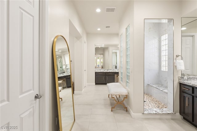 bathroom with recessed lighting, visible vents, vanity, a walk in shower, and tile patterned flooring