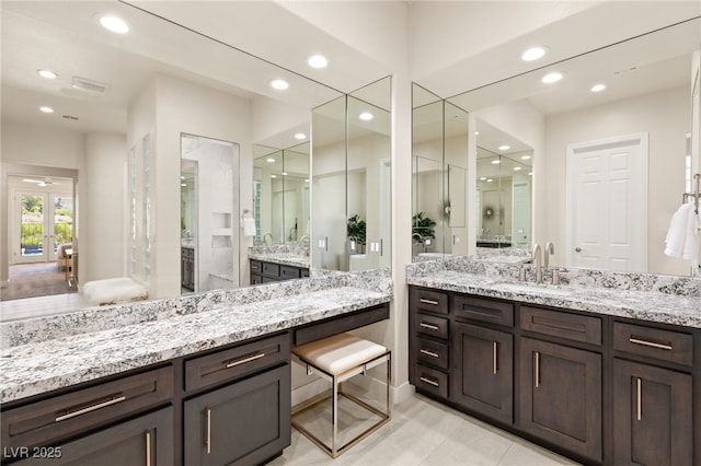 bathroom featuring a stall shower, a sink, and recessed lighting