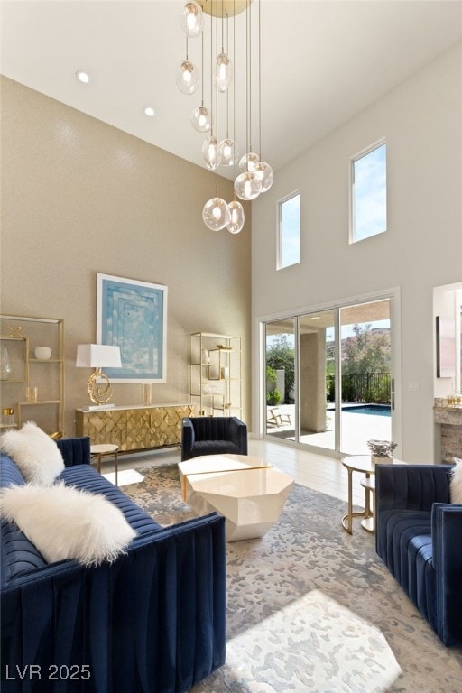 living room featuring a towering ceiling and an inviting chandelier