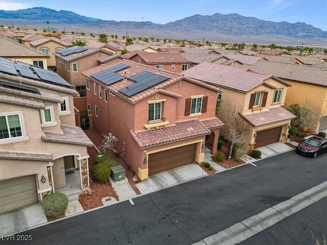 birds eye view of property with a mountain view and a residential view