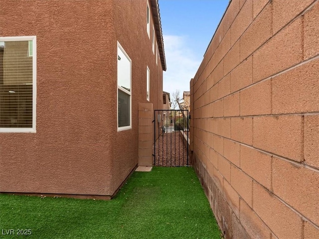 view of home's exterior with fence and stucco siding