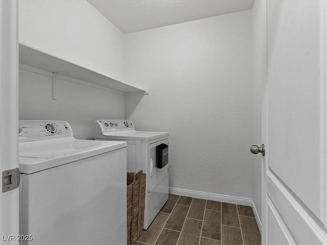 laundry room featuring washer and dryer, laundry area, baseboards, and wood tiled floor