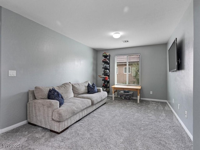 living area featuring carpet floors, visible vents, and baseboards