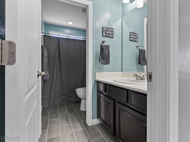 full bath featuring toilet, wood finish floors, and vanity