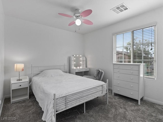 carpeted bedroom with a ceiling fan, visible vents, and baseboards