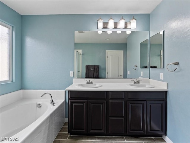 full bathroom featuring plenty of natural light, a sink, and a bath