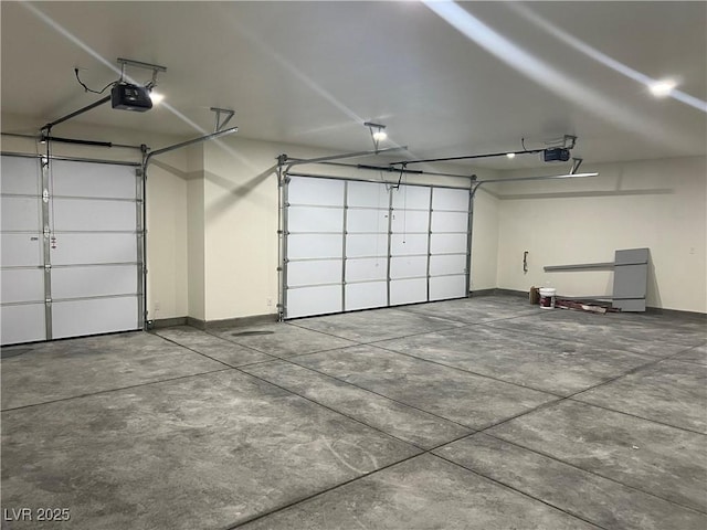garage featuring baseboards and a garage door opener