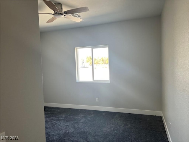 unfurnished room featuring dark colored carpet, a ceiling fan, and baseboards