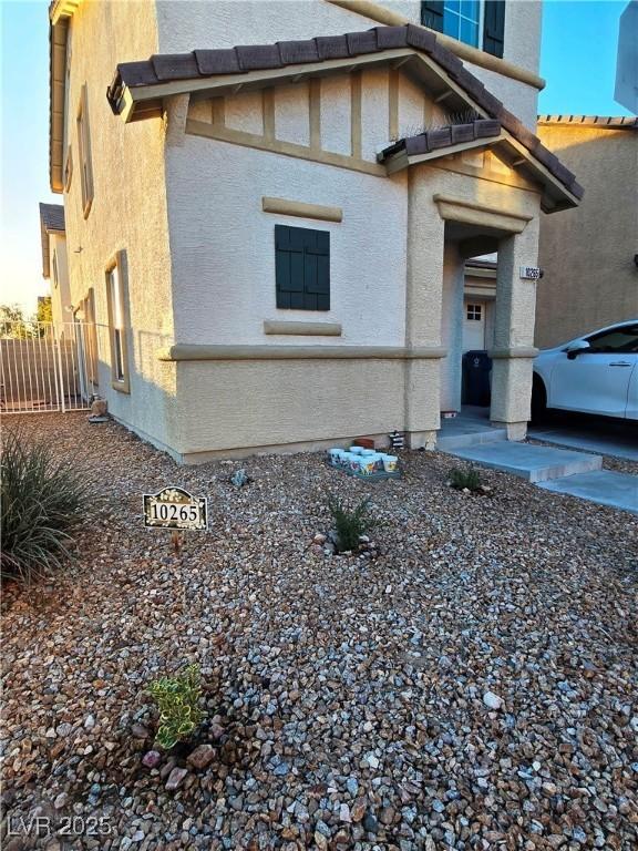 view of property exterior with fence and stucco siding