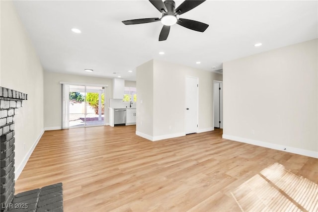 unfurnished living room with light wood-type flooring, baseboards, and recessed lighting