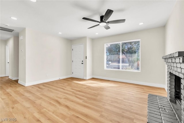 unfurnished living room featuring a fireplace, recessed lighting, visible vents, light wood-type flooring, and baseboards