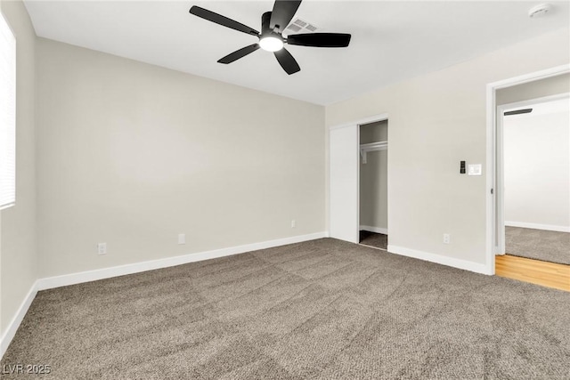 unfurnished bedroom with carpet floors, visible vents, ceiling fan, and baseboards