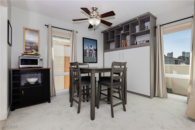 dining room with a ceiling fan and a toaster