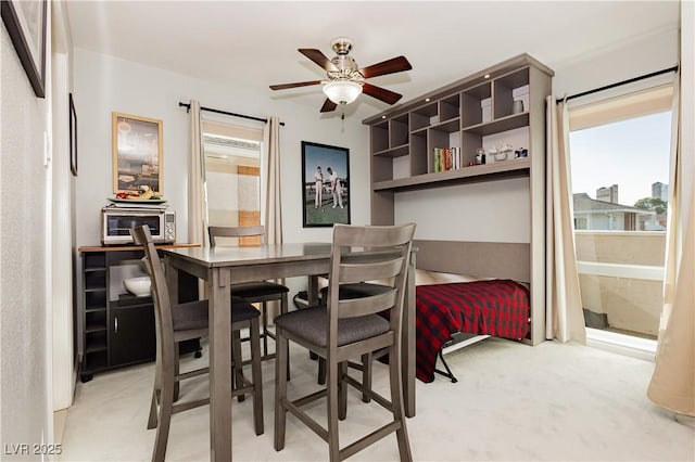 dining area featuring a toaster and ceiling fan