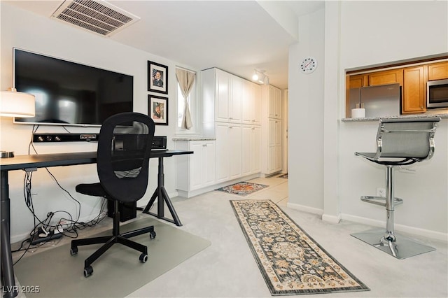 office space with visible vents and baseboards