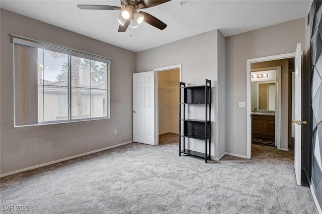 unfurnished bedroom featuring carpet floors, baseboards, and a ceiling fan