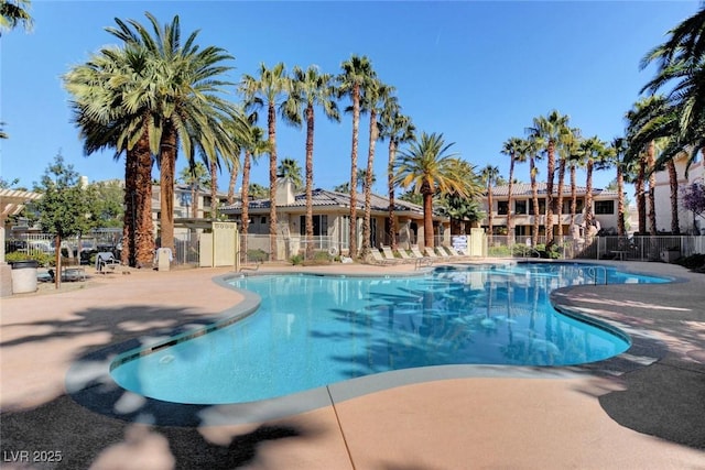 pool featuring fence and a patio