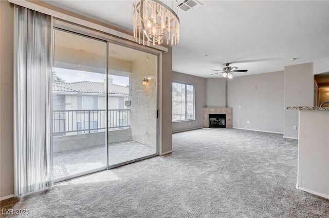 unfurnished living room with ceiling fan, a fireplace, visible vents, baseboards, and carpet