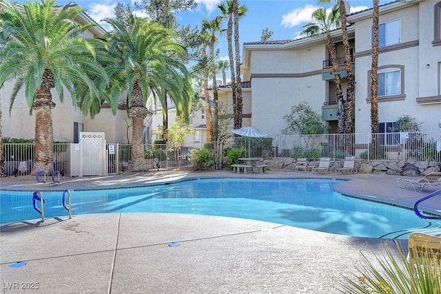 pool featuring a patio area and fence